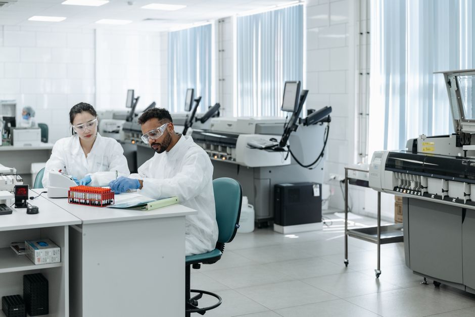 Team of researchers in a modern lab analyzing scientific data for medical research.